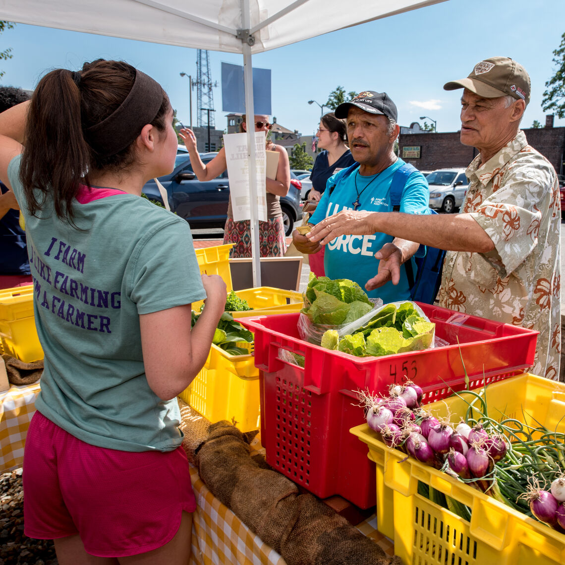 Two gentlemen purchase produce at the Stonehill Mobile Market with their HIP Incentive